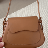 Closer look of tan crossbody bag with wide strap