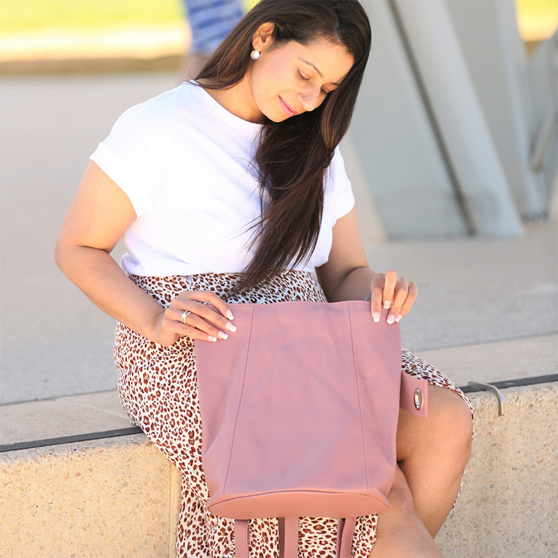 Pink pebbled leather backpack on model
