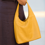Mustard leather shoulder bag on model